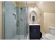 Updated bathroom with a stylish glass-enclosed shower, dark vanity, decorative mirror, and sleek fixtures at 3708 Colonel Vanderhorst Cir, Mount Pleasant, SC 29466