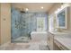 Bright bathroom featuring a glass shower, soaking tub, dual sinks, and marble tile floor at 3708 Colonel Vanderhorst Cir, Mount Pleasant, SC 29466