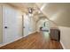 A carpeted bedroom with a ceiling fan, wooden floors, and access to a bathroom with a toilet at 3708 Colonel Vanderhorst Cir, Mount Pleasant, SC 29466
