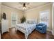 Bedroom with a floral-patterned bed, hardwood floors, and ample natural light at 3708 Colonel Vanderhorst Cir, Mount Pleasant, SC 29466