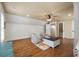 Open bonus room features hardwood floors, a ceiling fan, shiplap accent wall, and two comfortable armchairs at 3708 Colonel Vanderhorst Cir, Mount Pleasant, SC 29466