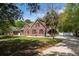 Classic brick residence with a neatly landscaped front yard and a winding driveway, exuding timeless appeal at 3708 Colonel Vanderhorst Cir, Mount Pleasant, SC 29466