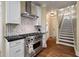 Gourmet kitchen features a stainless steel range, custom tile work, and open access to stairs at 3708 Colonel Vanderhorst Cir, Mount Pleasant, SC 29466