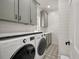 Laundry room featuring sage cabinets, stylish tile floors and updated appliances at 3708 Colonel Vanderhorst Cir, Mount Pleasant, SC 29466
