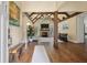 Spacious living room featuring a vaulted ceiling with exposed wood beams, a stone fireplace, and hardwood floors at 3708 Colonel Vanderhorst Cir, Mount Pleasant, SC 29466