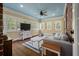 Cozy sunroom featuring hardwood floors, a light blue ceiling, and a charming brick fireplace at 3708 Colonel Vanderhorst Cir, Mount Pleasant, SC 29466
