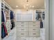 Large walk-in closet with custom shelving, a center island, and a chandelier at 3708 Colonel Vanderhorst Cir, Mount Pleasant, SC 29466