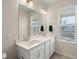 Elegant bathroom with double sinks, a large mirror, and modern lighting at 384 Ripple Park Dr, Summerville, SC 29486