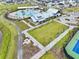 An aerial shot reveals a clubhouse and pool area with lush greenery and walking paths at 384 Ripple Park Dr, Summerville, SC 29486