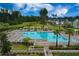 Aerial view of a large community pool with lounge chairs, cabanas, trees, and green space at 384 Ripple Park Dr, Summerville, SC 29486