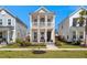 Two-story home with inviting front porch and balcony, a well-manicured lawn, and classic architectural details at 384 Ripple Park Dr, Summerville, SC 29486
