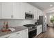 Close up of kitchen with white cabinets, stainless steel appliances, subway tile backsplash and granite countertops at 384 Ripple Park Dr, Summerville, SC 29486