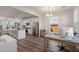 Bright open-concept kitchen with stainless steel appliances and view into an office space with a desk by the window at 384 Ripple Park Dr, Summerville, SC 29486
