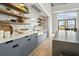 A modern kitchenette featuring geometric backsplash, farmhouse sink, and open shelving at 384 Ripple Park Dr, Summerville, SC 29486