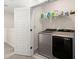 Laundry room with stainless steel washer and dryer, white shelving, and a closed white door at 384 Ripple Park Dr, Summerville, SC 29486