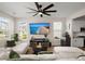 Beautiful living room featuring a large flat-screen TV, hardwood floors, and comfortable white sofa with green pillows at 384 Ripple Park Dr, Summerville, SC 29486