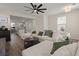Bright living room with a ceiling fan, hardwood floors, and comfortable white sofa, open to the kitchen at 384 Ripple Park Dr, Summerville, SC 29486