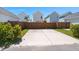 A full parking pad with a dark wooden fence and grass on either side separating the homes at 384 Ripple Park Dr, Summerville, SC 29486
