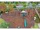 Aerial shot of a community playground featuring slides, swings, climbing structures, and a shaded seating area at 384 Ripple Park Dr, Summerville, SC 29486