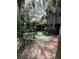 Outdoor patio with table and chairs surrounded by lush landscaping at 4113 Buccaneer Rd, Isle of Palms, SC 29451