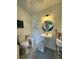 Quaint bathroom with a unique mirror, toilet and white beadboard walls at 4113 Buccaneer Rd, Isle of Palms, SC 29451