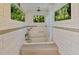 Modern bathroom with soaking tub, beautiful tile work, and lots of natural light at 4113 Buccaneer Rd, Isle of Palms, SC 29451