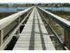 Long wooden dock extending over marshland to boat slips and waterfront at 4113 Buccaneer Rd, Isle of Palms, SC 29451