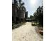 Exterior home view with a sandy driveway and surrounding lush greenery at 4113 Buccaneer Rd, Isle of Palms, SC 29451