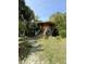 Exterior view of a charming home surrounded by lush greenery and a wooden staircase at 4113 Buccaneer Rd, Isle of Palms, SC 29451