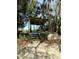 Rustic outdoor deck with weathered wood, surrounded by lush trees and sandy ground at 4113 Buccaneer Rd, Isle of Palms, SC 29451