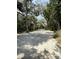 Expansive property featuring a sand driveway surrounded by lush trees and tropical plants at 4113 Buccaneer Rd, Isle of Palms, SC 29451