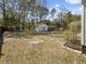 Spacious backyard with mature trees and a detached garage at 4701 Ivydale Dr, North Charleston, SC 29405