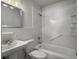 Clean white bathroom featuring a shower-tub combo and pedestal sink at 4701 Ivydale Dr, North Charleston, SC 29405