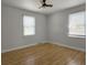 Bedroom with wood floors, two windows providing natural light, and white trim at 4701 Ivydale Dr, North Charleston, SC 29405