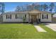 Inviting one-story house with a lush green lawn and traditional facade at 4701 Ivydale Dr, North Charleston, SC 29405