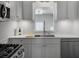 Bright, renovated kitchen with white cabinets, tile backsplash, and stainless steel appliances at 4701 Ivydale Dr, North Charleston, SC 29405
