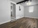 Open-concept room with hardwood flooring and modern lighting fixtures at 4701 Ivydale Dr, North Charleston, SC 29405