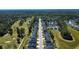 Aerial view of homes lining a street next to golf course, showcasing community layout and proximity to recreational amenities at 505 Kilarney Rd, Summerville, SC 29483