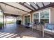 Relaxing covered back patio with a ceiling fan, elegant outdoor furniture, and a sliding glass door leading inside at 505 Kilarney Rd, Summerville, SC 29483