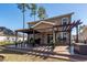 A spacious stamped concrete patio, with a pergola and outdoor seating, is perfect for entertaining and enjoying the outdoors at 505 Kilarney Rd, Summerville, SC 29483