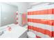 Fresh bathroom with gray vanity, modern fixtures and a bright coral striped shower curtain at 505 Kilarney Rd, Summerville, SC 29483
