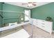 Modern bedroom with bed frame, white dresser, and view of the window at 505 Kilarney Rd, Summerville, SC 29483