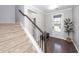 An inviting entryway is adjacent to the staircase, featuring stylish decor and a glass paneled door at 505 Kilarney Rd, Summerville, SC 29483