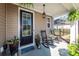Inviting front porch with rocking chairs, potted flowers, and a decorative welcome mat, creating a warm entry at 505 Kilarney Rd, Summerville, SC 29483