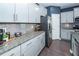 A gourmet kitchen offers granite countertops, stainless steel appliances, and gray cabinetry at 505 Kilarney Rd, Summerville, SC 29483