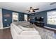 Cozy living room with stylish gray sectional sofa, ceiling fan, and view of the outdoor scenery at 505 Kilarney Rd, Summerville, SC 29483