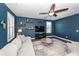 Comfortable living room with blue walls, stylish shelves, ceiling fan and gray sectional sofa at 505 Kilarney Rd, Summerville, SC 29483