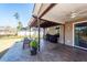 Covered patio featuring ceiling fan, outdoor dining, grill, and spacious backyard at 505 Kilarney Rd, Summerville, SC 29483