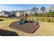 Fenced backyard play area with a mulch base, featuring a playset with a slide and swings for outdoor fun at 505 Kilarney Rd, Summerville, SC 29483