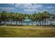 Resort-style pool area featuring palm trees, lounge chairs, umbrellas, and a cabana for residents' relaxation and enjoyment at 505 Kilarney Rd, Summerville, SC 29483